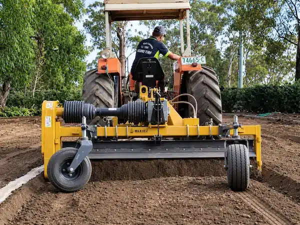 Man on tractor doing ground preparation work for turf